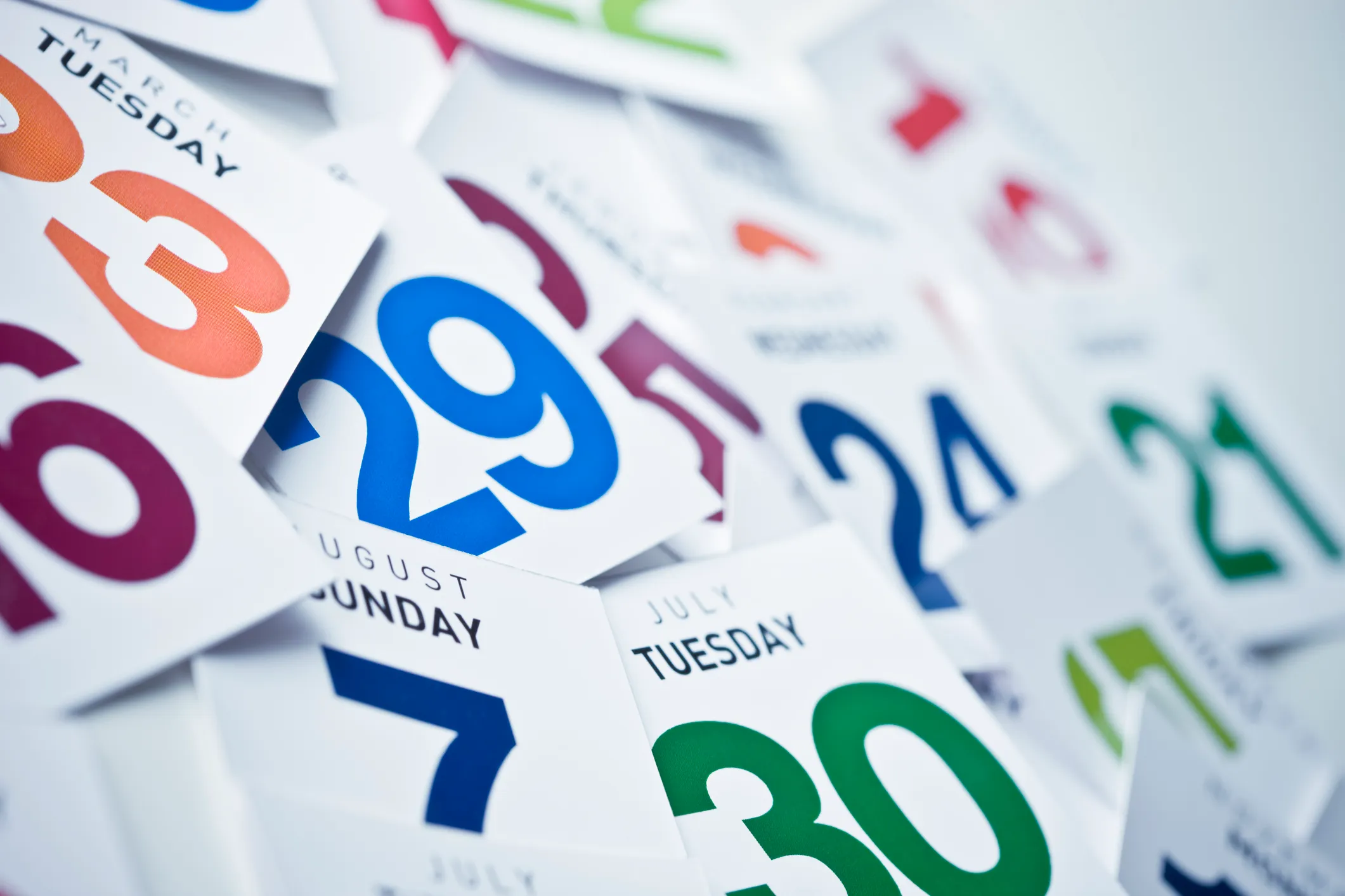Calendar pages turning in sequence, symbolizing the passage of time in longitudinal research studies where participants are tracked over multiple weeks or months, representing CloudResearch's large-scale longitudinal project with IARPA